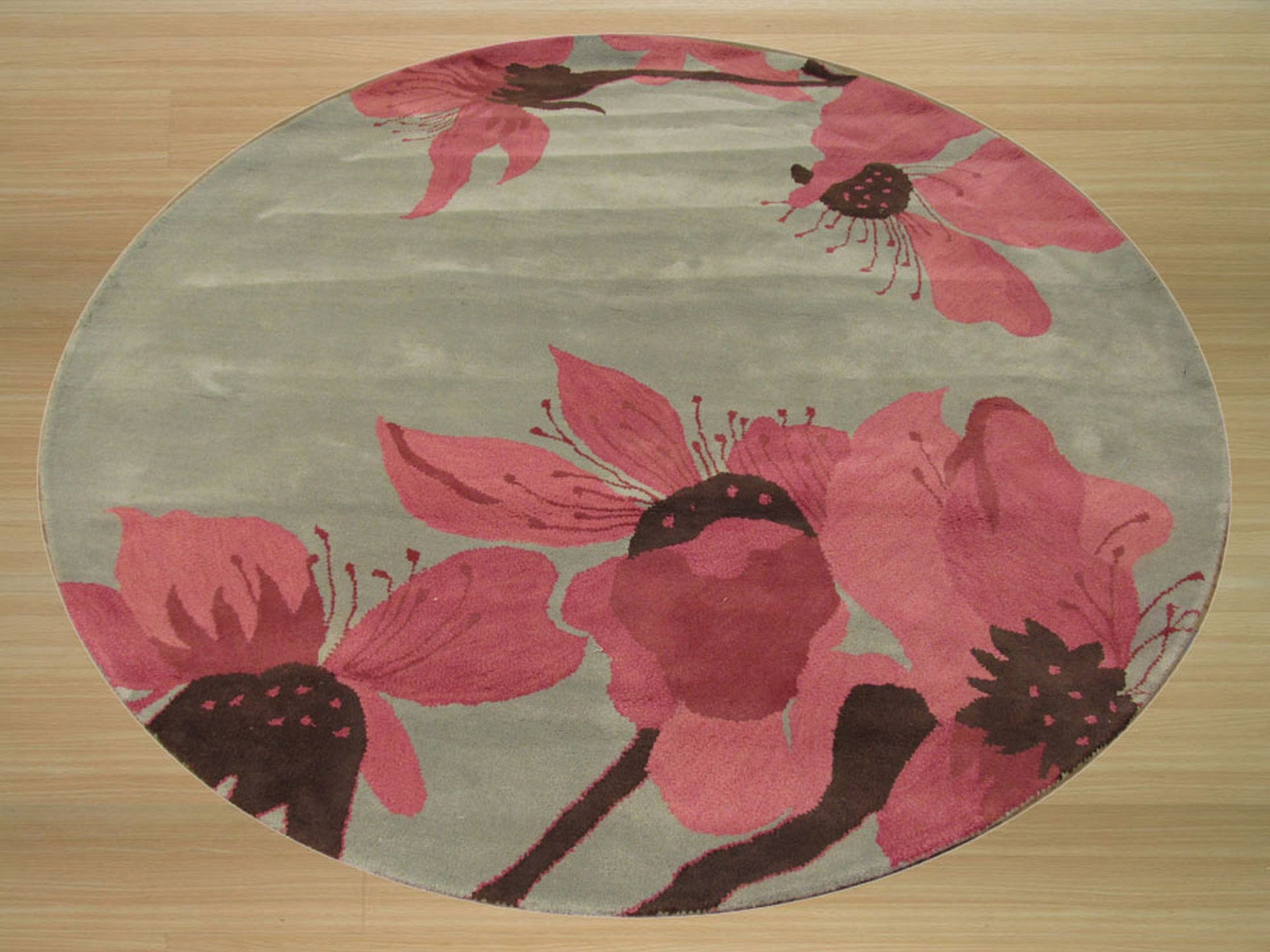 Elena Kira Blue Hand Tufted Wool Rug, displayed on a light hardwood floor, its vibrant blue hues and intricate hand-tufted design complementing the neutral backdrop.