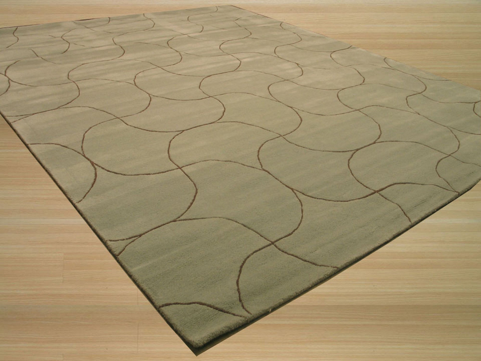 Sumptuous Maya Blue Hand Tufted Wool Rug, a rich blue wool rug with a subtle, textured design, rests on a light hardwood floor, showcasing its plush pile and vibrant color.