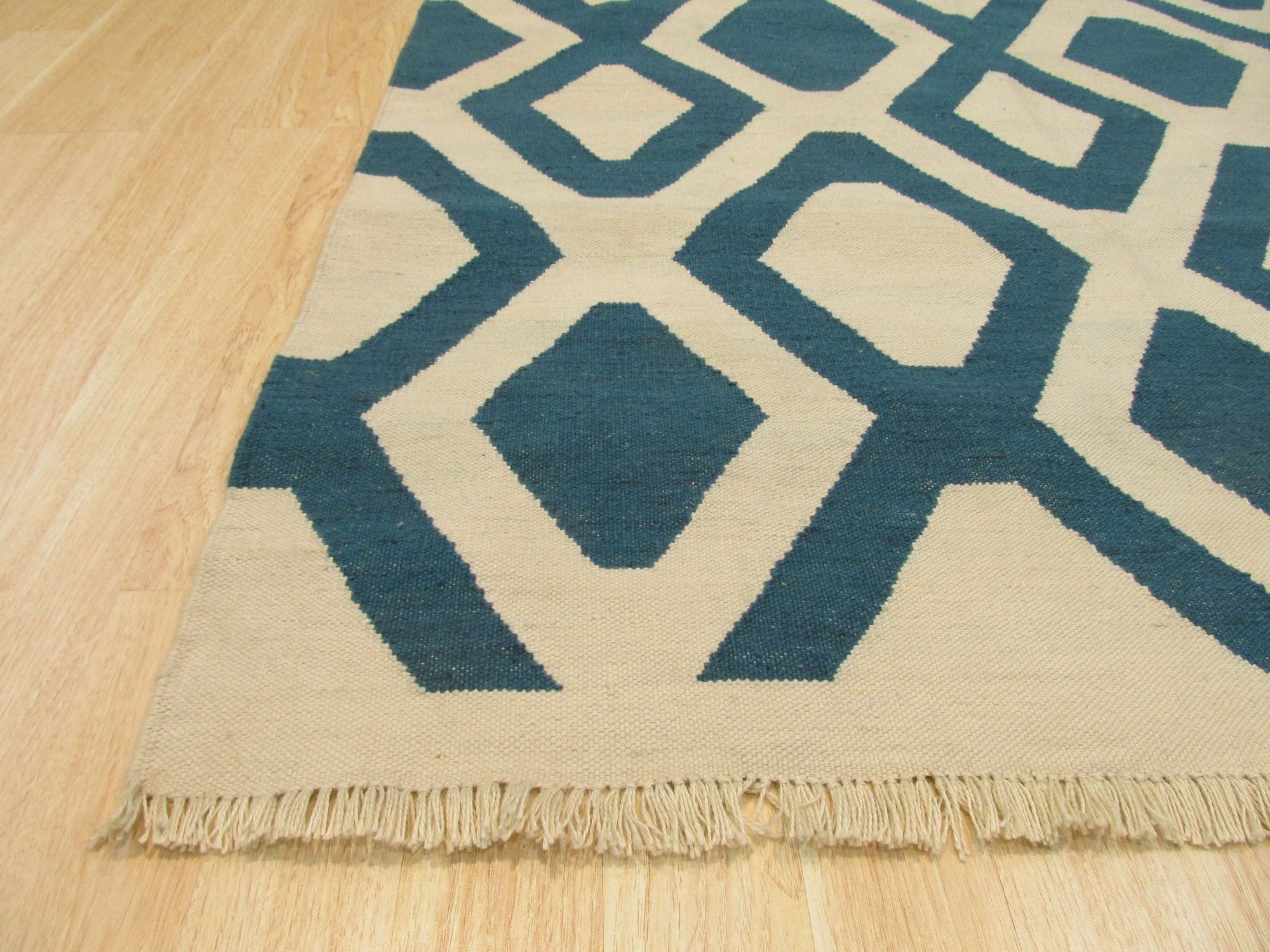 Opulent Kilim Blue Hand Knotted Rug, its intricate geometric patterns in deep blues, creams, and hints of rust, create a sophisticated and timeless design.