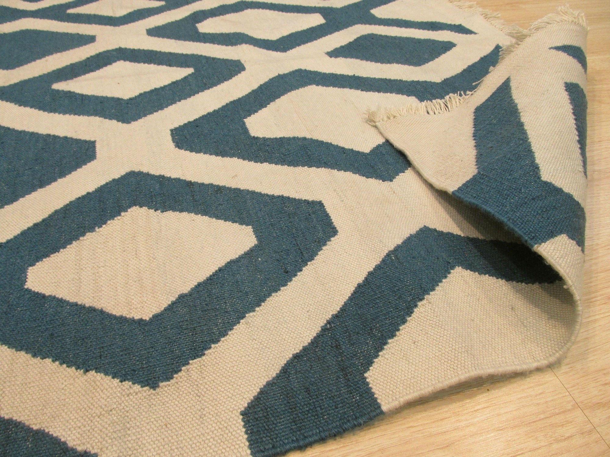 Opulent Kilim Blue Hand Knotted Rug, displaying vibrant blues and intricate kilim patterns, filling a room with warm light and complementing neutral furniture.
