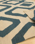 Opulent Kilim Blue Hand Knotted Rug, displaying vibrant blues and intricate kilim patterns, filling a room with warm light and complementing neutral furniture.