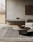 Rhea Elena Purple Hand Knotted Wool Rug, displaying its intricate pattern and rich purple hues, positioned in a bright, contemporary living space.