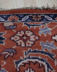 Lush Rustic Rust Hand Knotted Wool Rug, a blend of earthy rust tones in hand-knotted wool, adding warmth and texture to a living space with hardwood flooring.