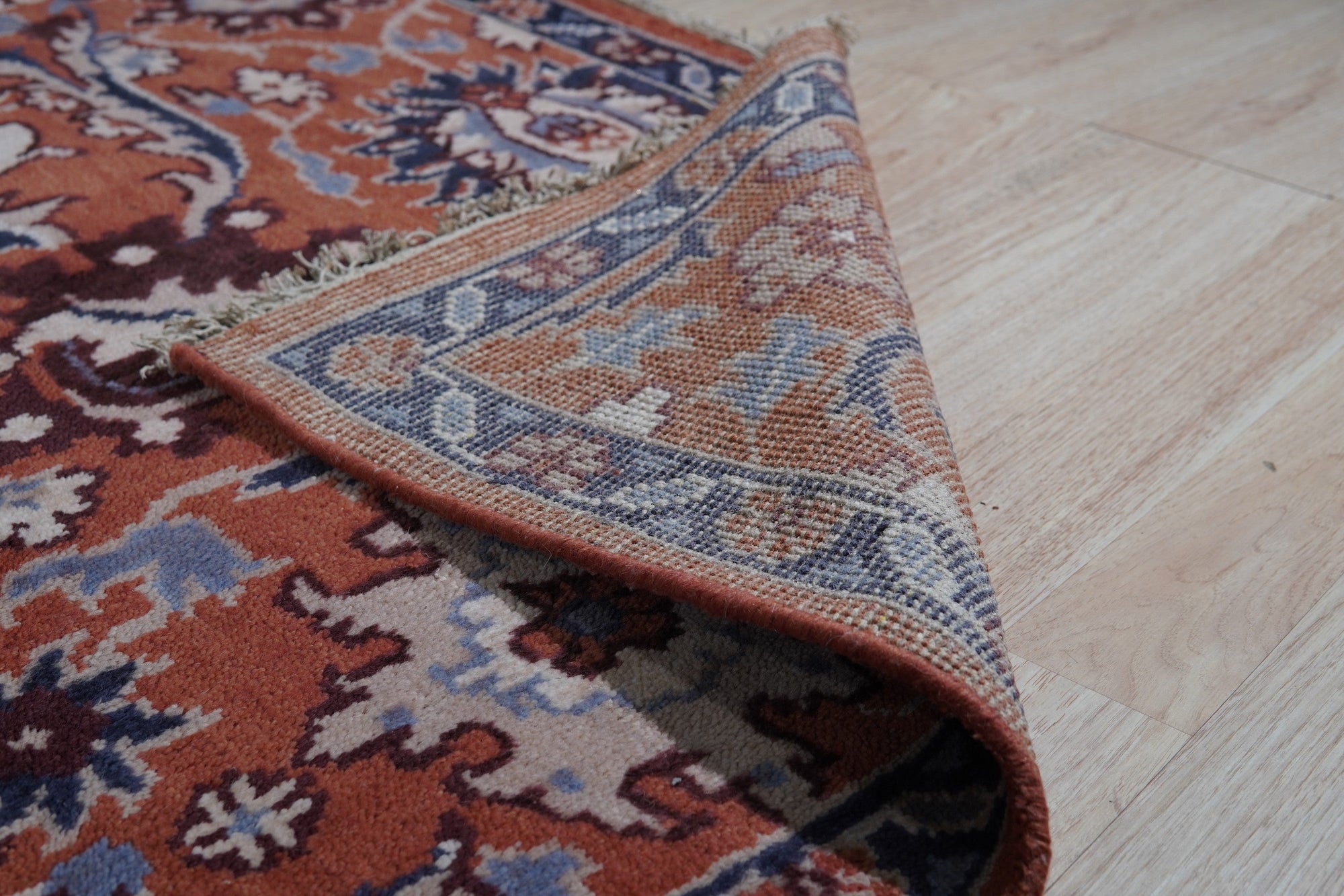 Lush Rustic Rust Hand Knotted Wool Rug, displaying warm rust tones and hand-knotted texture, seen in a styled interior setting.