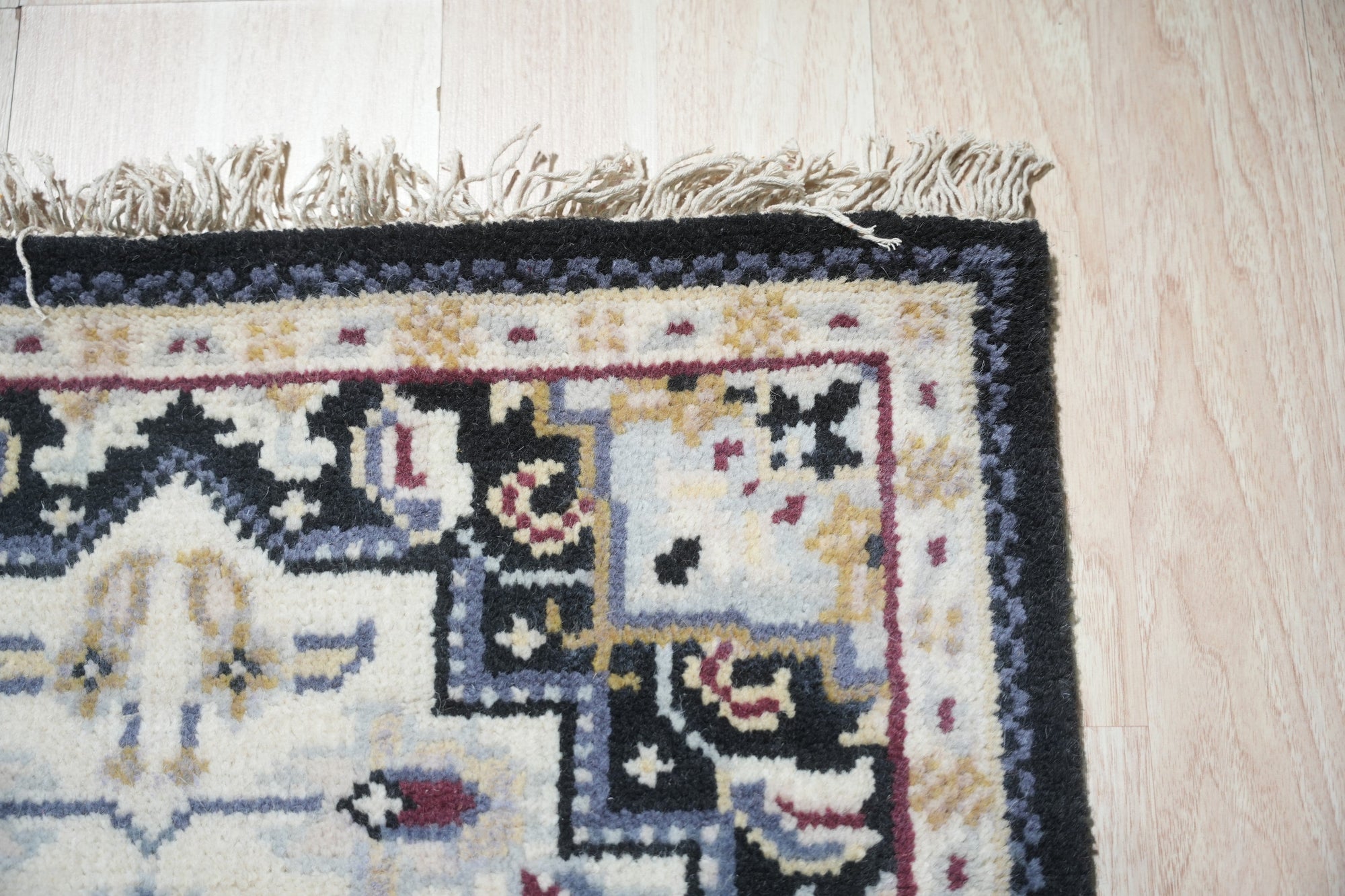 Luxurious Traditional Beige Hand Knotted Wool Rug, showcasing intricate floral and geometric motifs in soft beige tones; detail highlights the wool's hand-knotted construction.