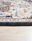 Luxurious Traditional Beige Hand Knotted Wool Rug, displaying intricate floral patterns in beige and muted greens on a cream field, presented in a well-lit room setting.