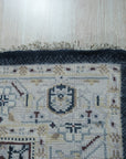 Luxurious Traditional Beige Hand Knotted Wool Rug, seen in a warm, inviting setting. Beige wool rug with intricate, traditional patterns. Hand-knotted construction apparent in the detailed weave.