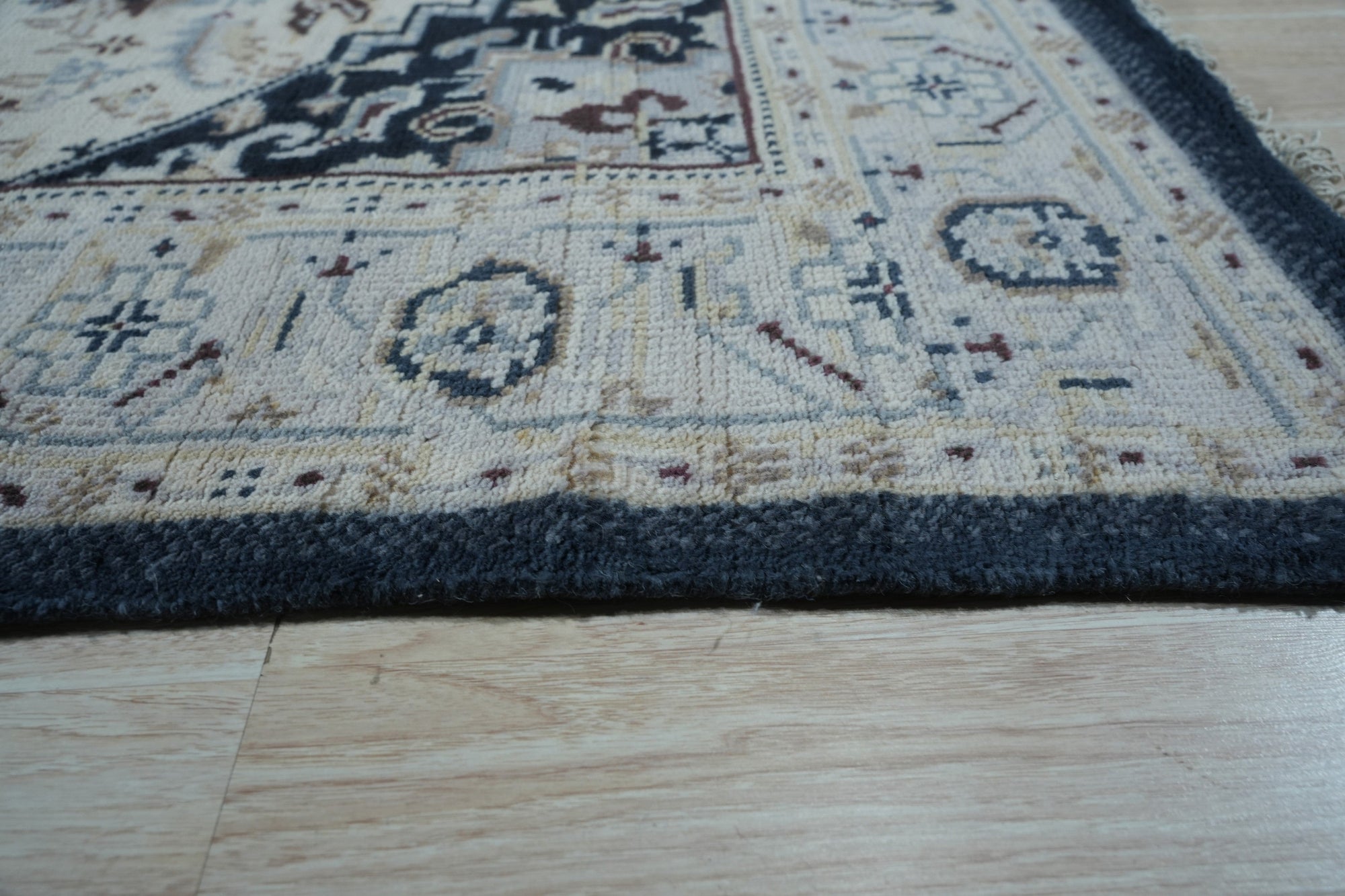 Luxurious Traditional Beige Hand Knotted Wool Rug, a beige wool rug with intricate traditional patterns, displayed in a home setting.