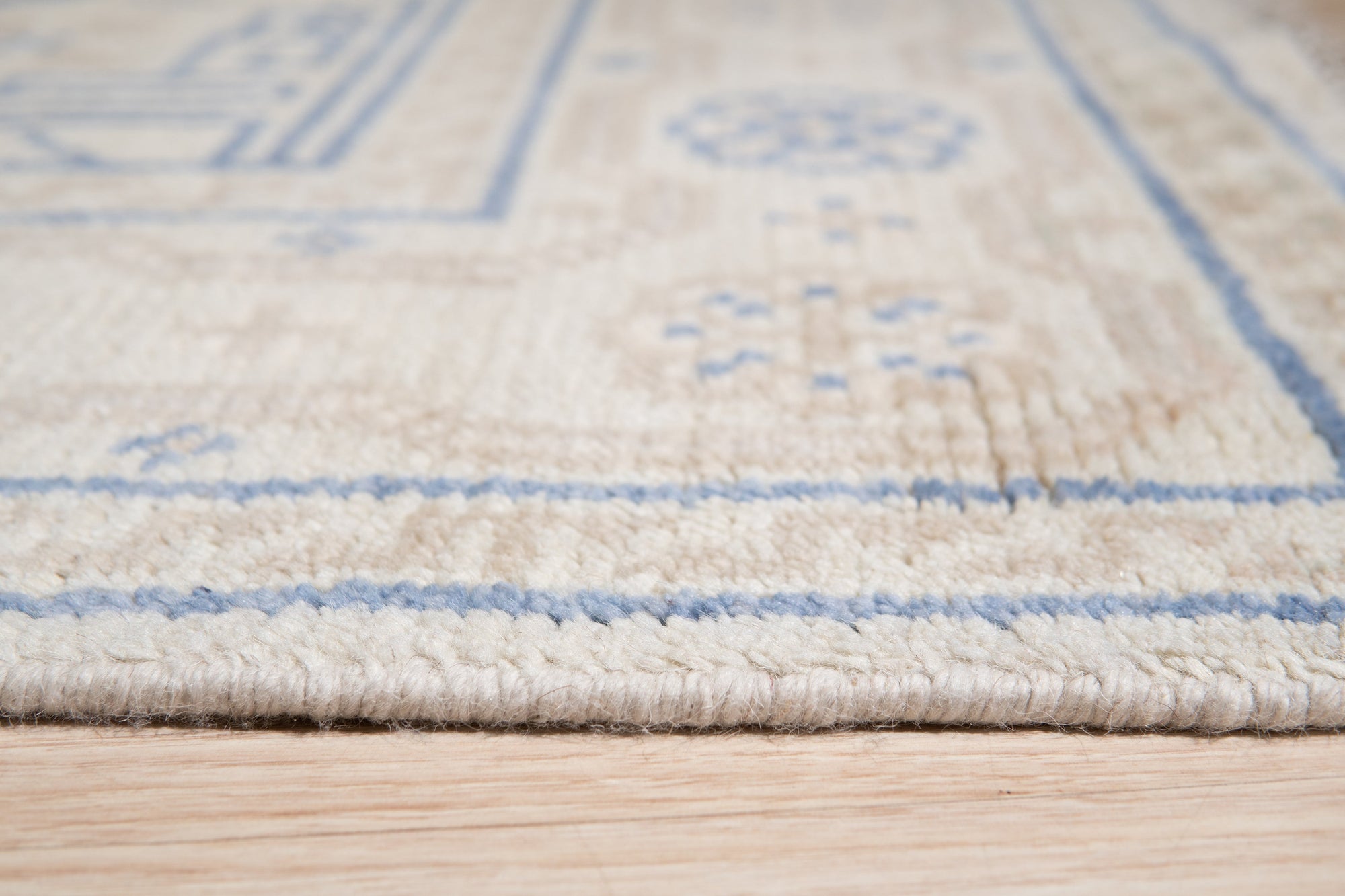 Ava Sophie Beige Hand Knotted Wool Rug displayed in a living room setting. Soft beige tones and hand-knotted wool construction create a luxurious feel underfoot.