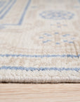 Ava Sophie Beige Hand Knotted Wool Rug displayed in a living room setting. Soft beige tones and hand-knotted wool construction create a luxurious feel underfoot.