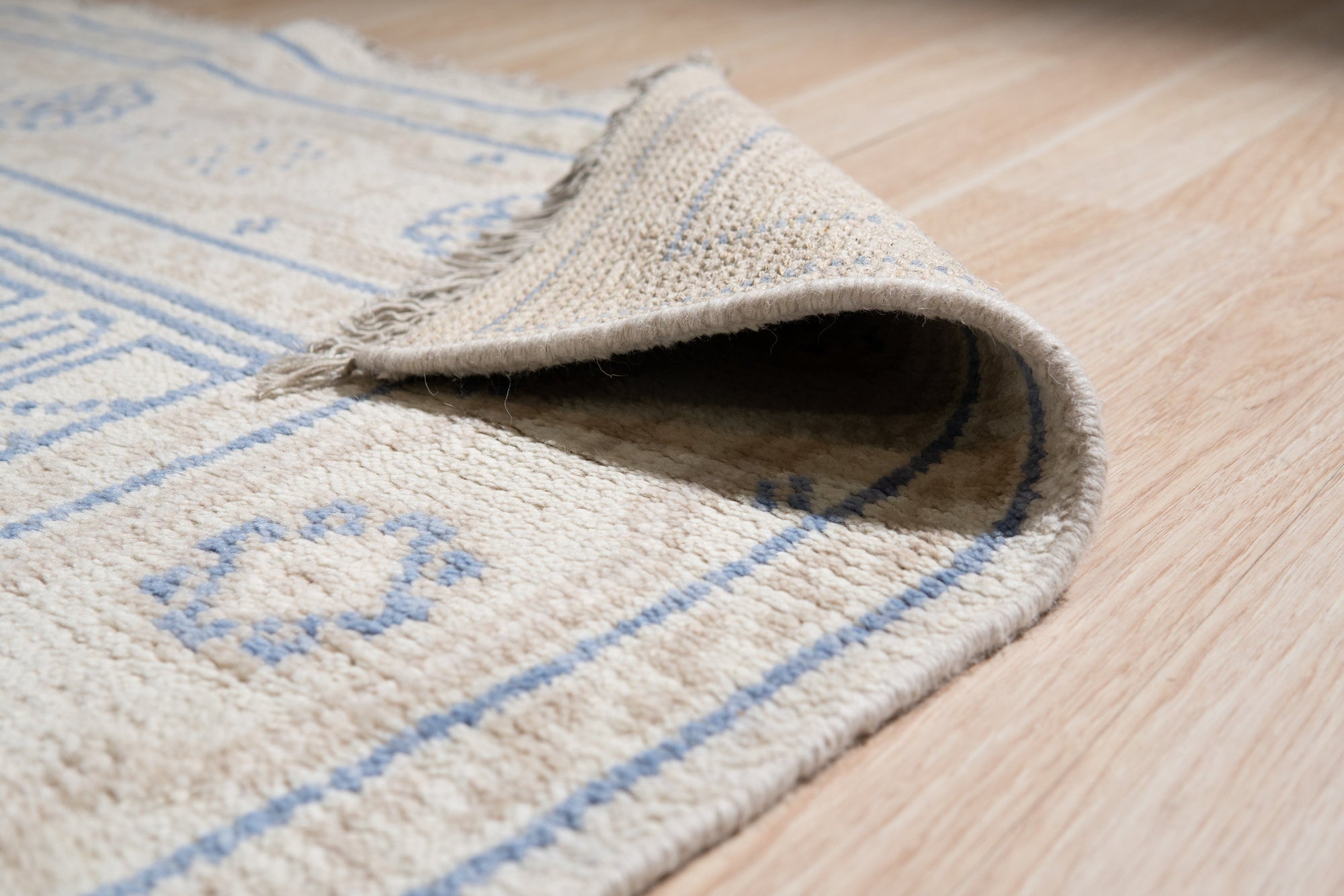 Ava Sophie Beige Hand Knotted Wool Rug, showcasing soft beige tones and intricate hand-knotted details in a warmly lit interior setting.