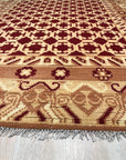 Chloe Trara Red Hand Knotted Wool Rug, a vibrant red wool rug with intricate, hand-knotted detailing, filling a bright, airy living space.