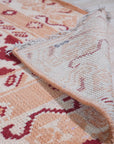 Chloe Trara Red Hand Knotted Wool Rug, bursts with vibrant red hues and intricate hand-knotted detail, adding warmth and texture to a bright, modern living space.
