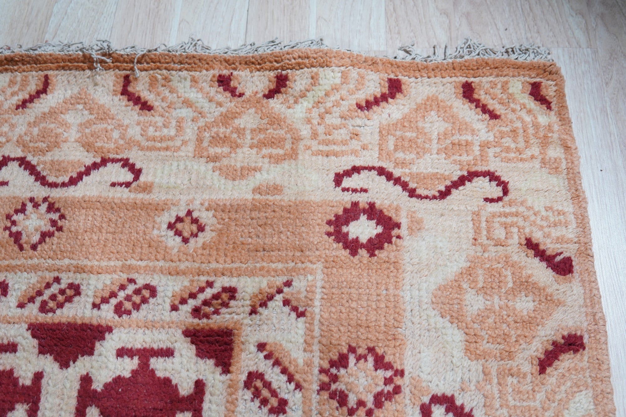 Chloe Trara Red Hand Knotted Wool Rug, deep reds and subtle textures interwoven in a hand-knotted wool masterpiece, displayed as room decor.