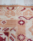 Chloe Trara Red Hand Knotted Wool Rug, deep reds and subtle textures interwoven in a hand-knotted wool masterpiece, displayed as room decor.