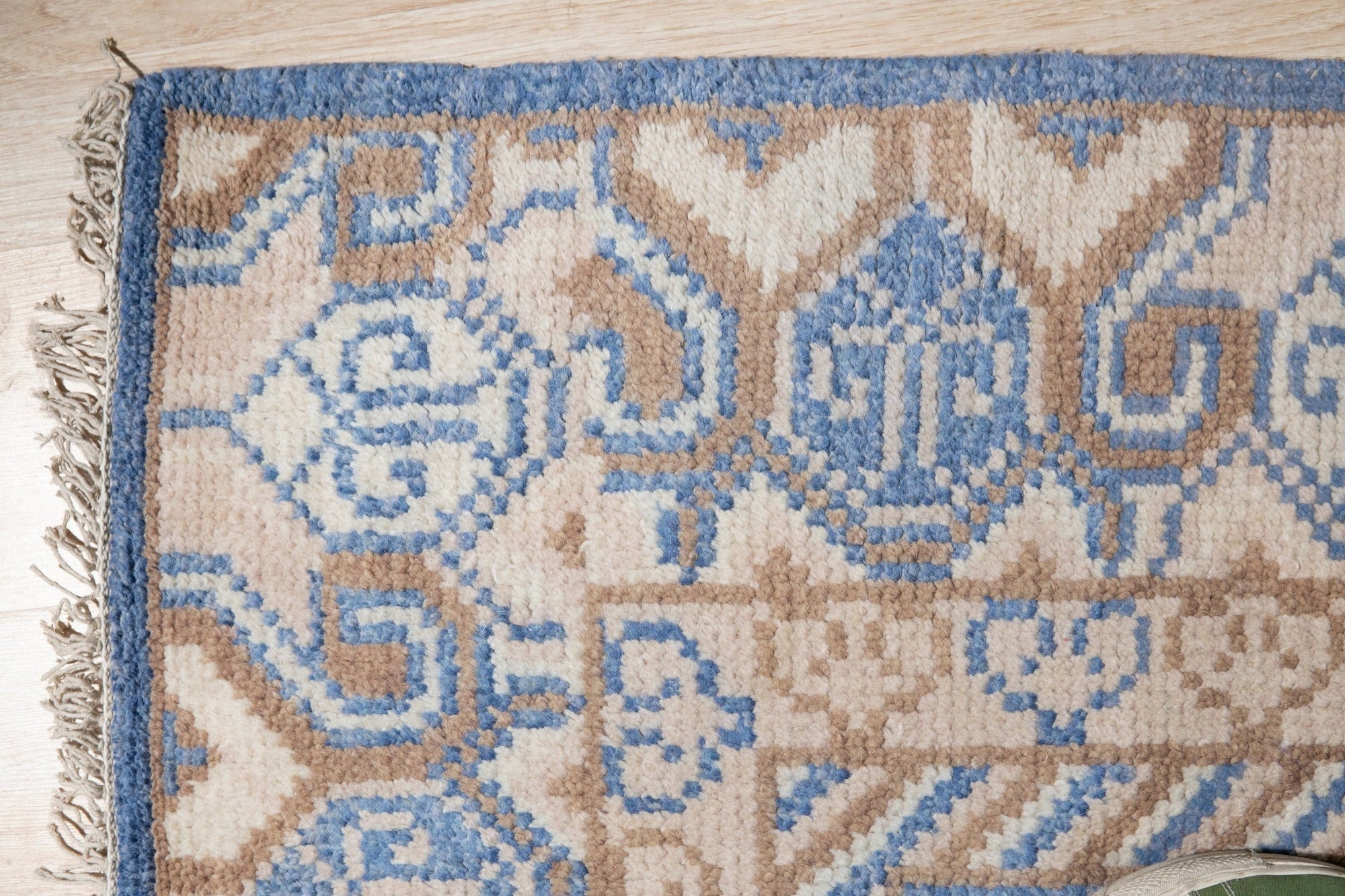 Handcrafted Traditional Blue Hand Knotted Wool Rug, a vibrant navy and cream wool rug featuring a classic, intricate pattern, displayed on a polished wooden floor in a warmly lit interior.