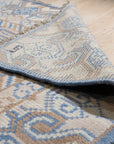 Handcrafted Traditional Blue Hand Knotted Wool Rug, showcases intricate patterns and rich blues against a warm background, lying flat and ready to add timeless elegance to any space.