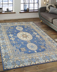 Handcrafted Traditional Blue Hand Knotted Wool Rug, deep blue and cream tones intertwine in an intricate traditional pattern, showcasing the rug's texture and detailed hand-knotted construction on a hardwood floor.