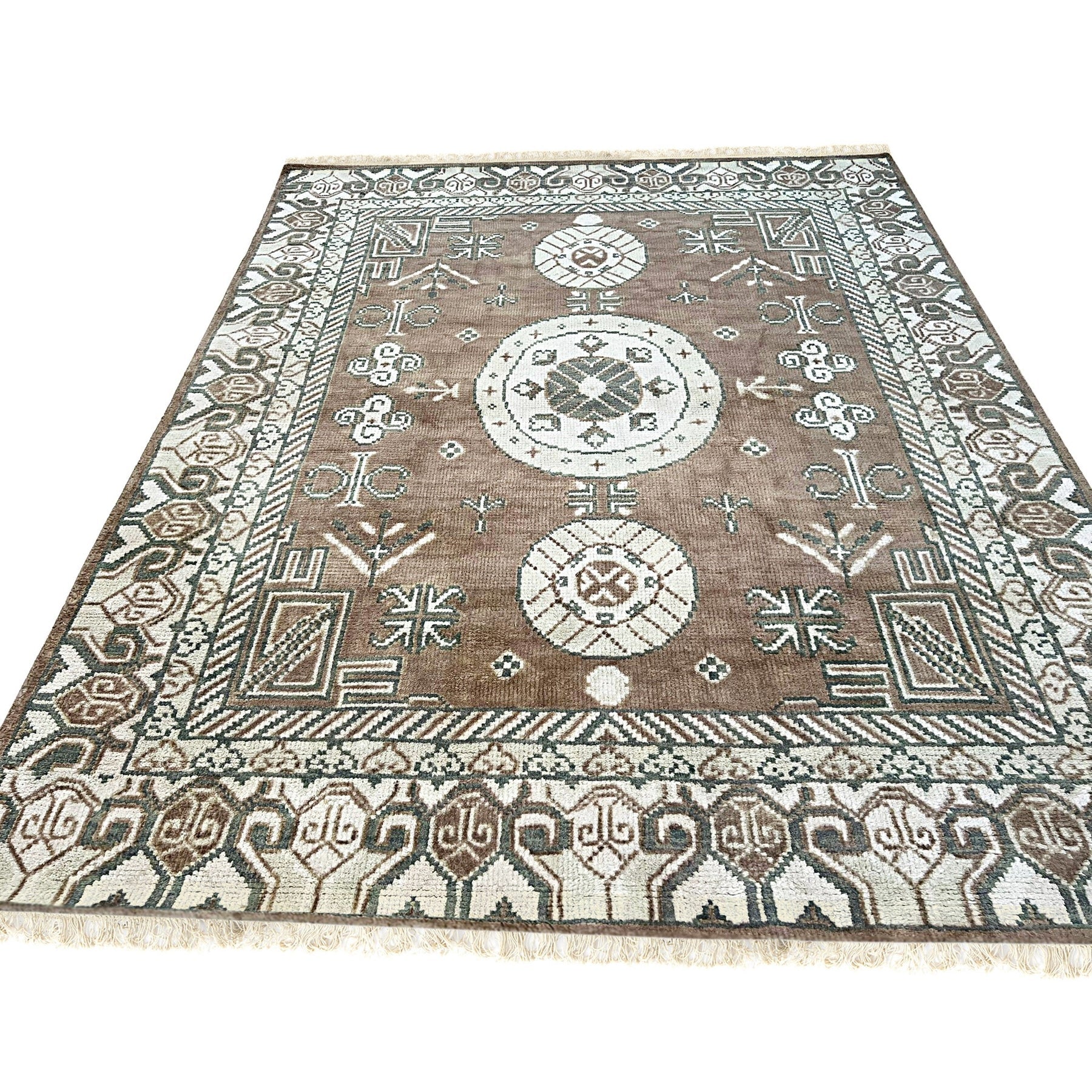 Trendy Traditional Brown Hand Knotted Wool Rug, warm brown wool pile displaying intricate traditional patterns, filling the floor space in a bright, welcoming room.