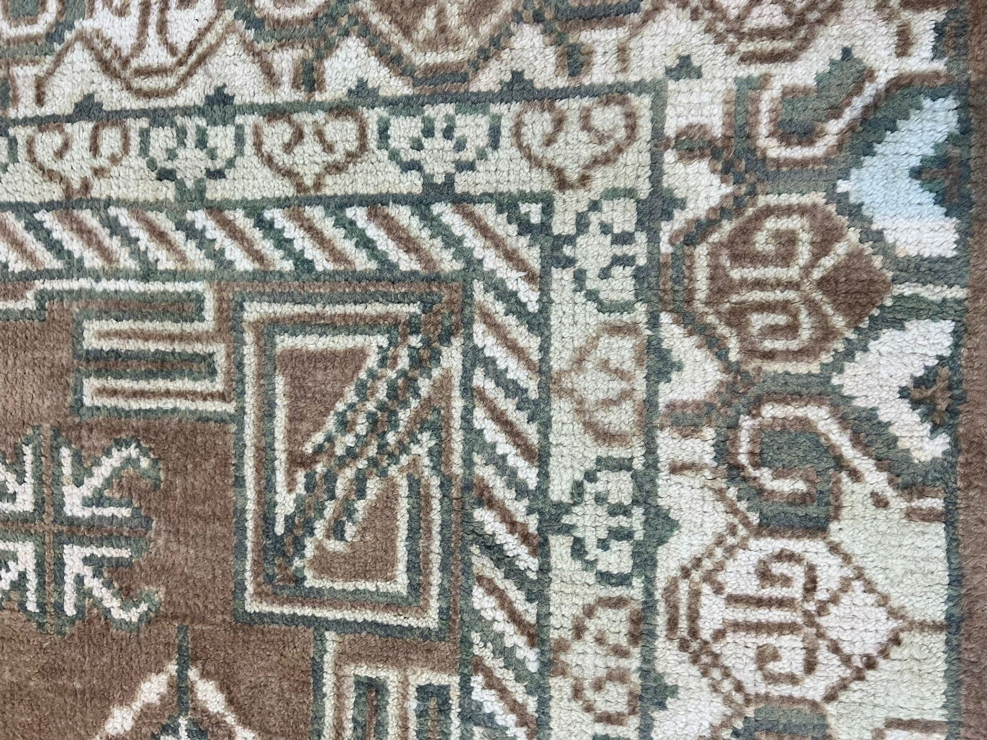 Trendy Traditional Brown Hand Knotted Wool Rug, a warm brown wool rug with a traditional pattern, displayed in a home setting with furniture.