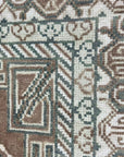 Trendy Traditional Brown Hand Knotted Wool Rug, a warm brown wool rug with a traditional pattern, displayed in a home setting with furniture.