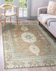 Trendy Traditional Brown Hand Knotted Wool Rug, showcasing its intricate design with warm brown hues and traditional motifs, lies flat on a wooden floor adding a touch of timeless elegance to a modern living space.