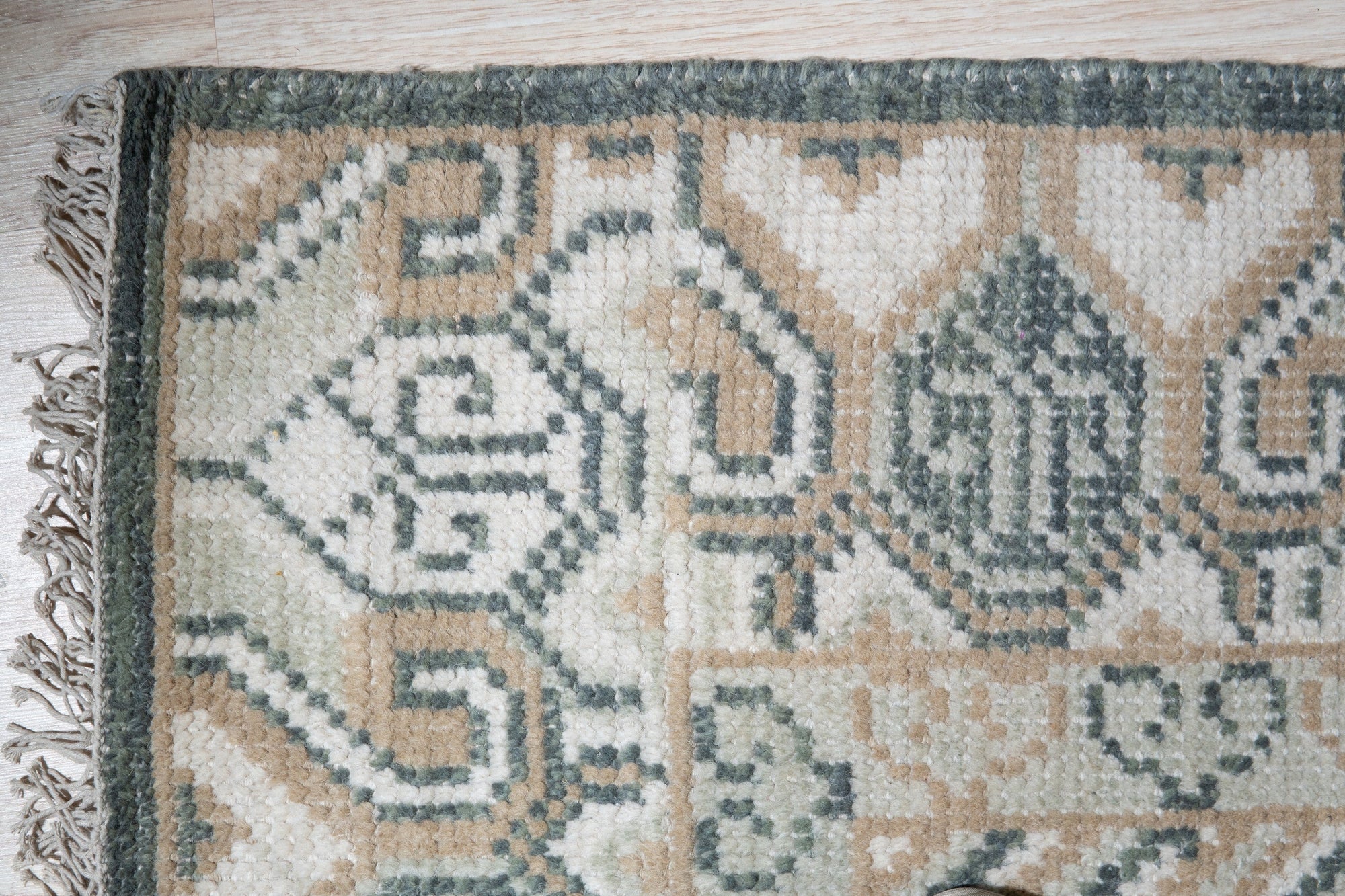 Rhea Traditional Green Hand Knotted Wool Rug, vibrant green wool rug with a traditional pattern, displayed in a bright living room setting.