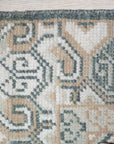 Rhea Traditional Green Hand Knotted Wool Rug, vibrant green wool rug with a traditional pattern, displayed in a bright living room setting.