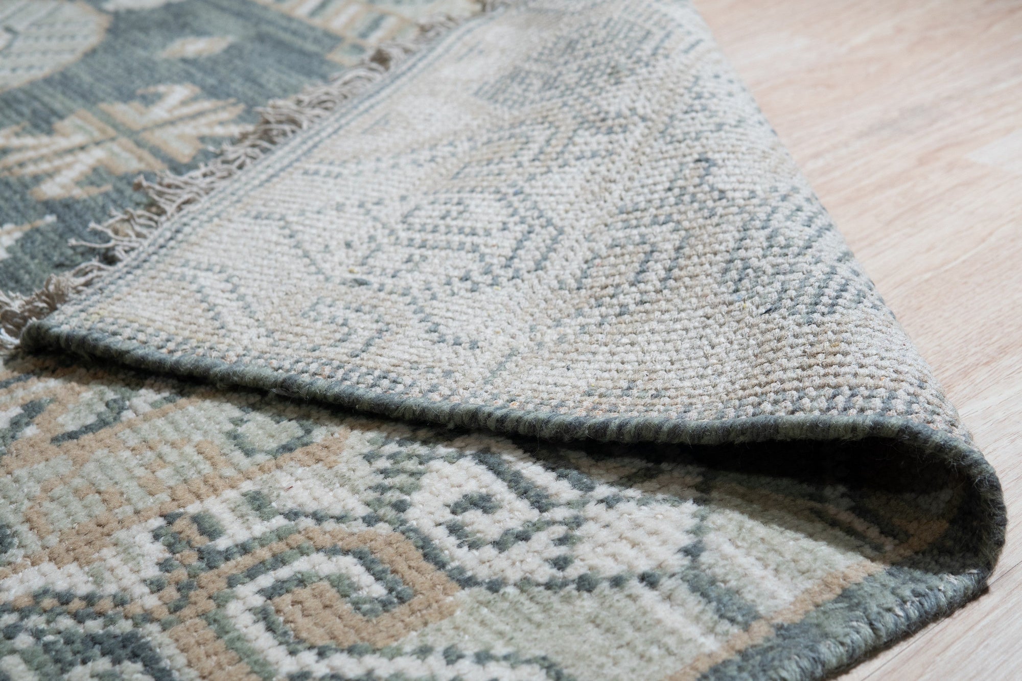 Rhea Traditional Green Hand Knotted Wool Rug, showcasing a detailed, traditional pattern in shades of green and cream, hand-knotted for enduring quality.