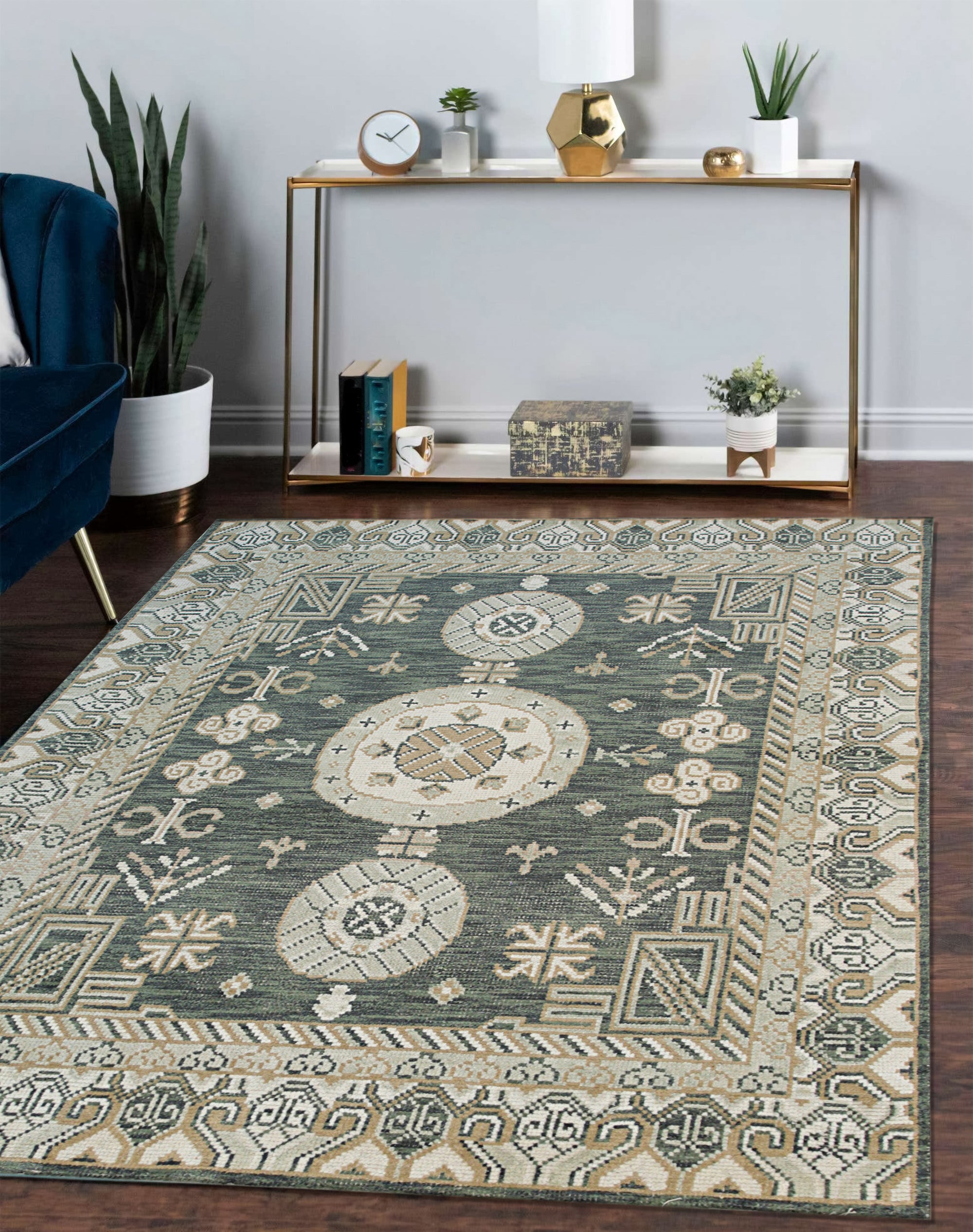 Rhea Traditional Green Hand Knotted Wool Rug, a lush green wool rug with an intricate traditional design, complementing a warmly lit living room setting with dark wood furniture and a patterned armchair.
