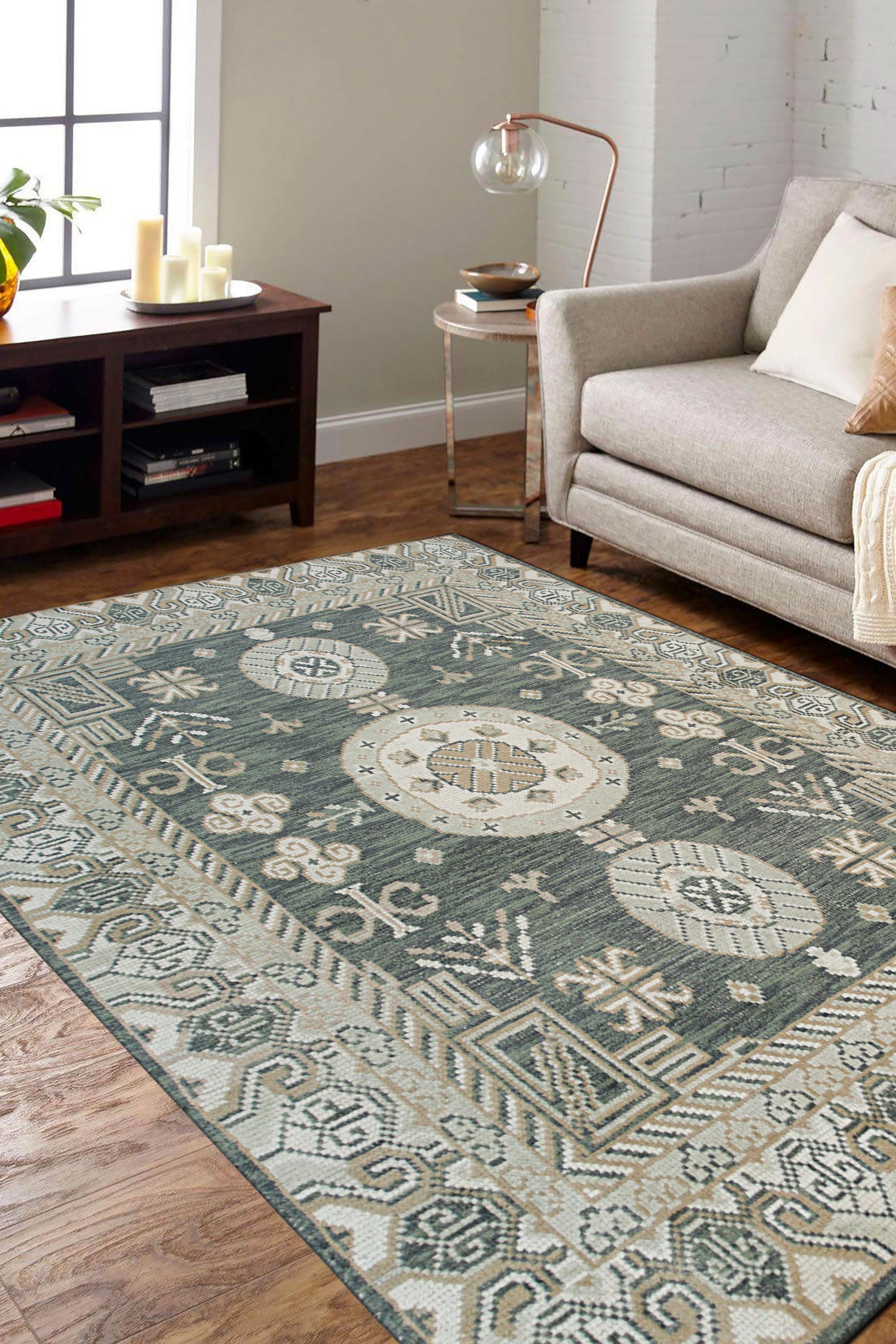 Rhea Traditional Green Hand Knotted Wool Rug, a rich green hand-knotted wool rug with intricate traditional patterns, displayed on a light hardwood floor, subtly textured and inviting.