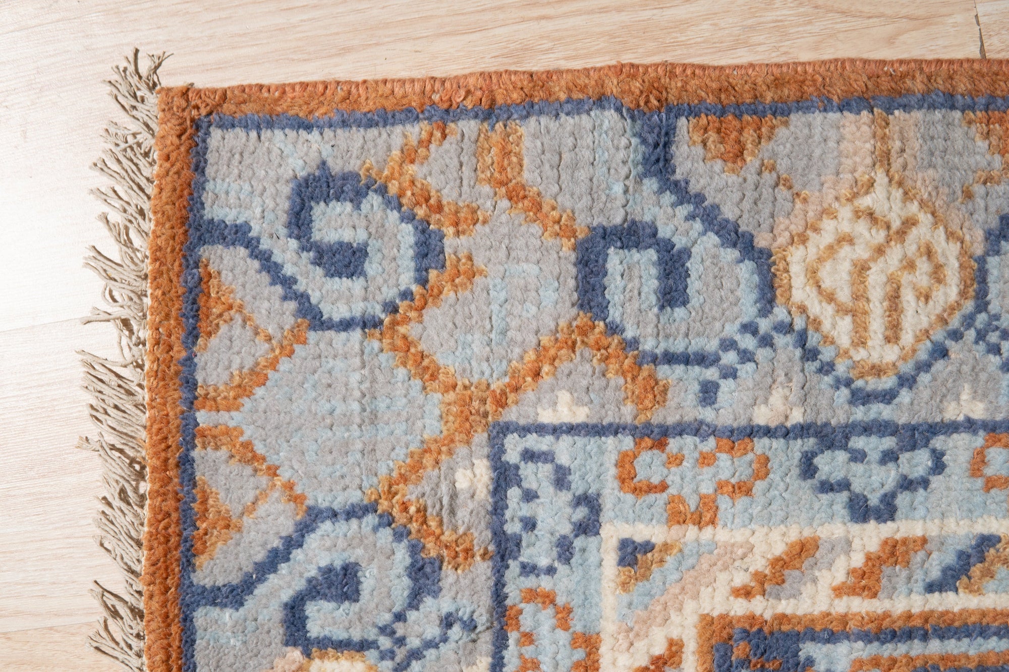 Jade Traditional Rust Hand Knotted Wool Rug, showcasing intricate traditional patterns in warm rust tones, hand-knotted wool construction lending texture and depth, seen in a styled room setting.