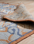 Jade Traditional Rust Hand Knotted Wool Rug, displaying intricate rust-toned patterns and hand-knotted construction in a well-lit interior setting.