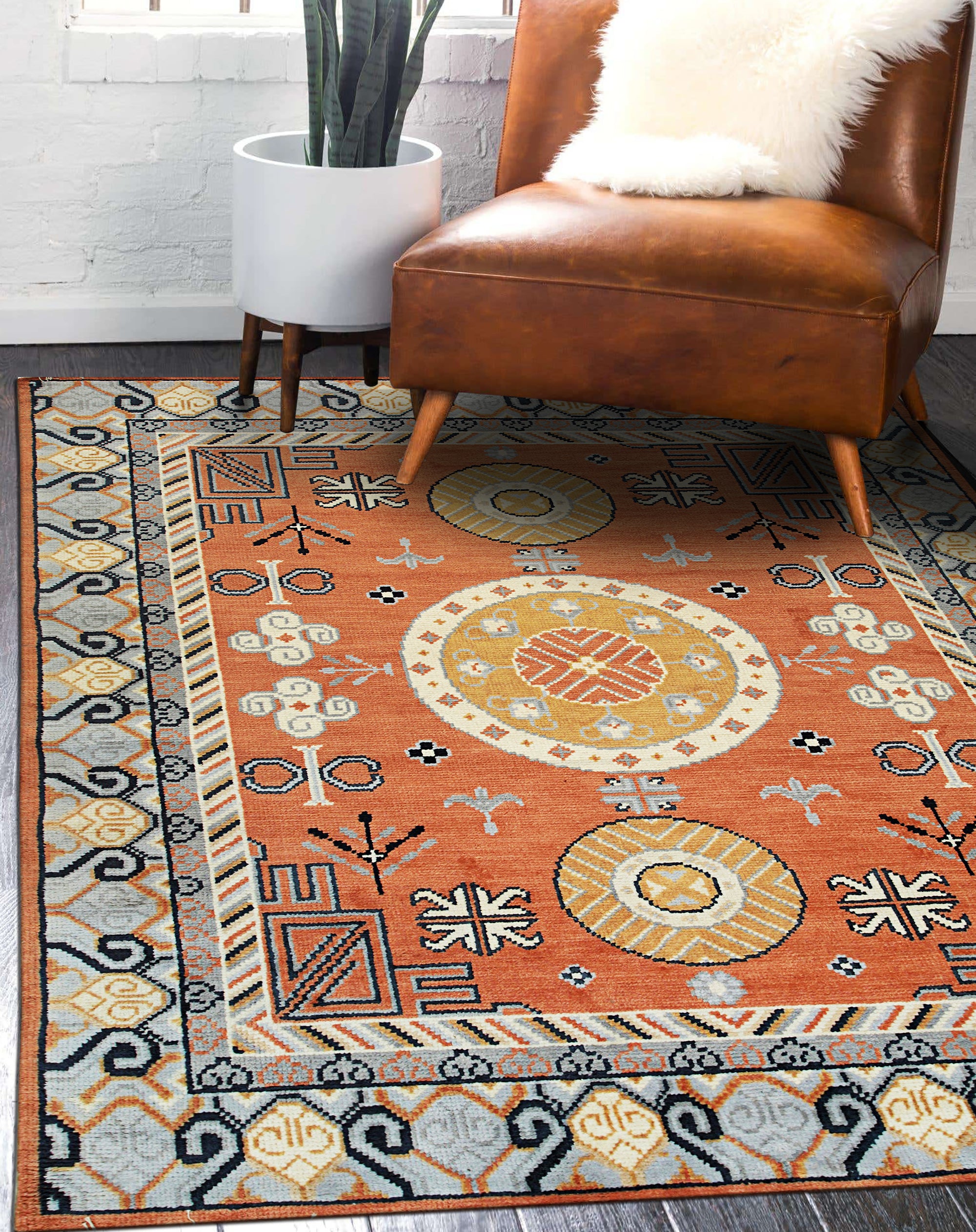 Jade Traditional Rust Hand Knotted Wool Rug, its intricate rust-toned patterns and hand-knotted wool texture visible, filling the frame in a detailed close-up.