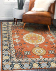 Jade Traditional Rust Hand Knotted Wool Rug, its intricate rust-toned patterns and hand-knotted wool texture visible, filling the frame in a detailed close-up.
