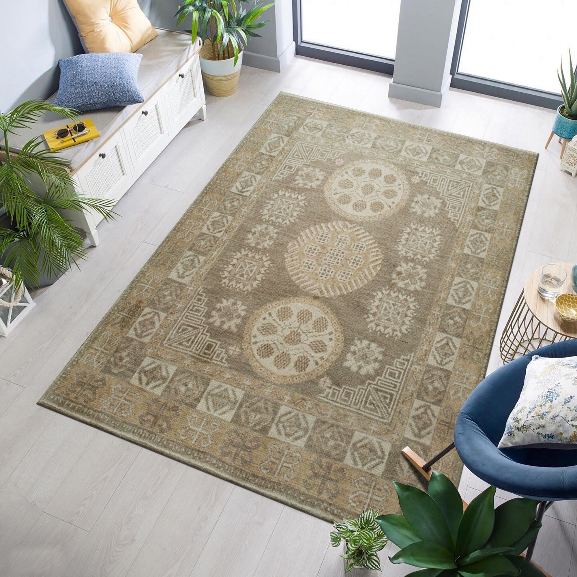 Classic Tessa Brown Hand Knotted Wool Rug, a warm brown wool rug with a subtle geometric pattern, partially visible beneath a light-colored sofa and wooden coffee table.