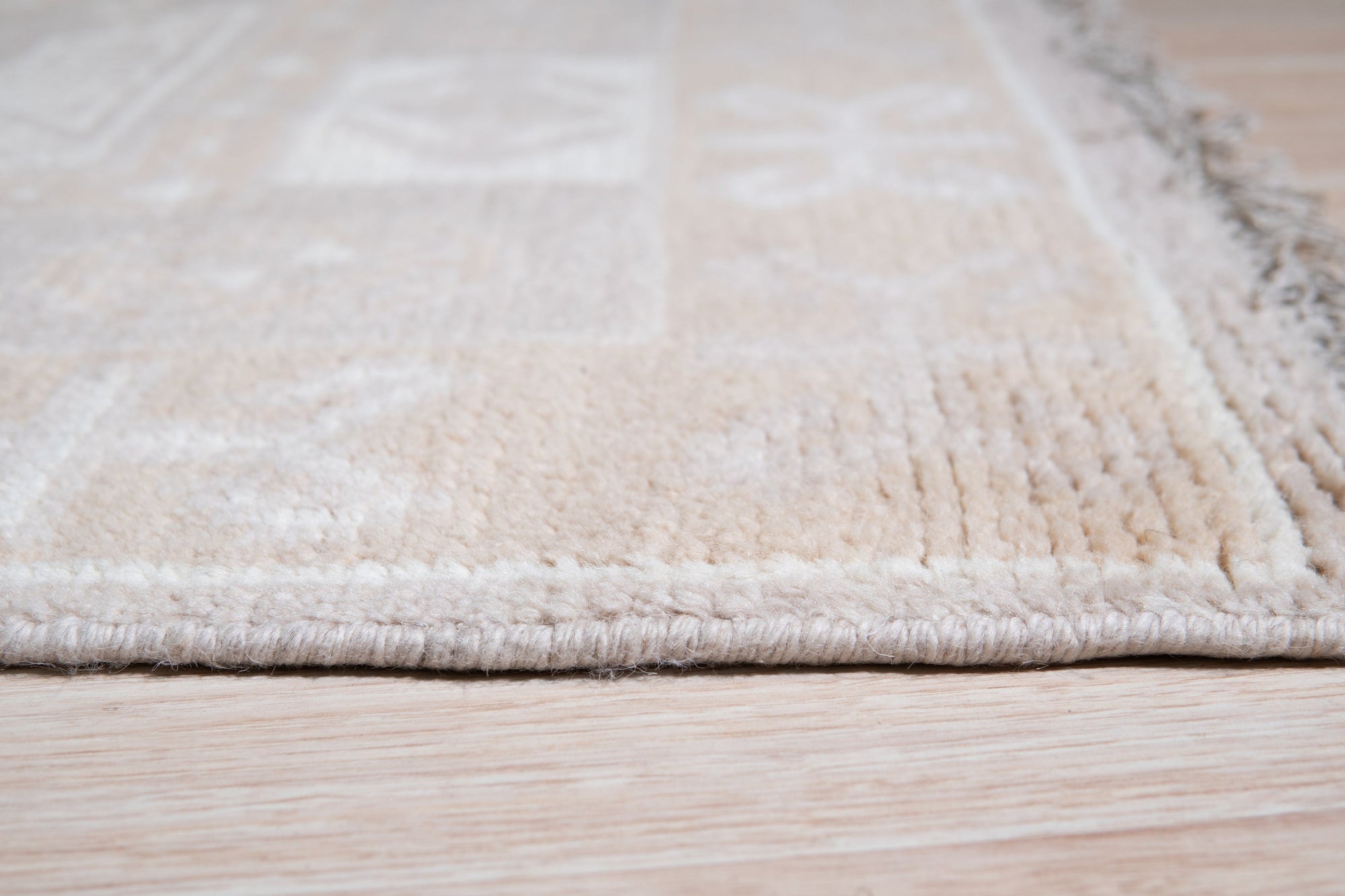 Classic Tessa Brown Hand Knotted Wool Rug, warm browns and creams weave a timeless pattern in this hand-knotted wool rug, nestled within a bright, modern living space.