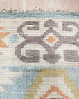 Freya Traditional Blue Hand Knotted Wool Rug displayed in a living room setting. Rich blues and intricate patterns define this hand-knotted wool rug, adding warmth and sophistication to the space.