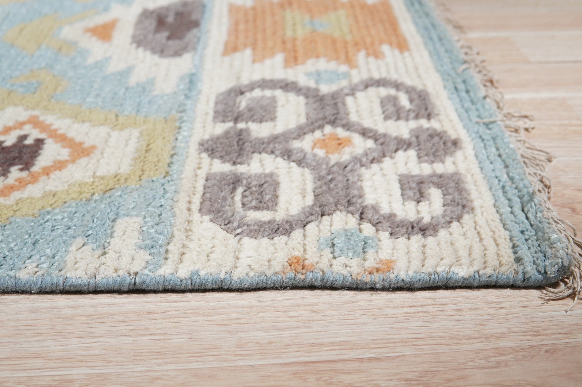 Freya Traditional Blue Hand Knotted Wool Rug, intricate patterns dance across a blue wool field, hand-knotted texture inviting touch, as seen in a lifestyle setting.