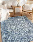 Ava Agra Blue Hand Knotted Wool & Bamboo Silk Rug, displaying its intricate pattern and luxurious sheen in a styled interior.