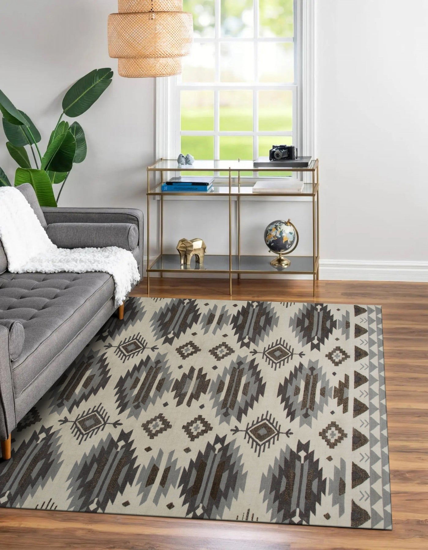 Chic Kilim Ivory Flatweave Rug, showcasing a cozy living room setting with a light wood coffee table, neutral sofa, and this ivory flatweave rug anchoring the space with its subtle geometric pattern.
