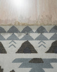 Chic Kilim Ivory Flatweave Rug, its intricate geometric patterns and subtle texture enhancing a bright, modern living space.