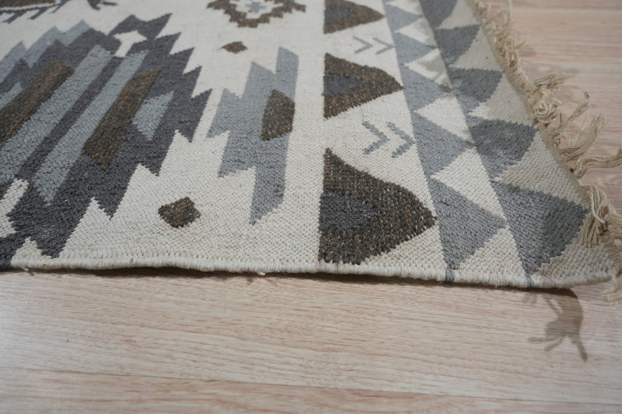 Here's the alt text generated based on your instructions:
 
 Chic Kilim Ivory Flatweave Rug, soft ivory tones and kilim-style geometric patterns blend seamlessly in a modern living room setting, showcasing its flatweave construction.