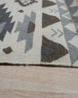 Here's the alt text generated based on your instructions:
Chic Kilim Ivory Flatweave Rug, soft ivory tones and kilim-style geometric patterns blend seamlessly in a modern living room setting, showcasing its flatweave construction.