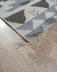 Chic Kilim Ivory Flatweave Rug, showcasing its geometric pattern in creamy ivory, laid in a bright living room setting.