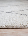 Jade Trellis Beige Hand Knotted Wool Rug, showcasing a calming beige palette and intricate trellis pattern, enriching a warmly lit living space.