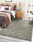 Captivating Moroccan Gray Hand Knotted Wool Rug, a textured expanse of gray wool adorned with subtle geometric patterns, lays elegantly on hardwood flooring, inviting warmth and understated sophistication.