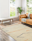 Delicate Moroccan Beige Hand Knotted Wool Rug, its intricate geometric pattern and subtle beige tones complementing a warmly lit interior.