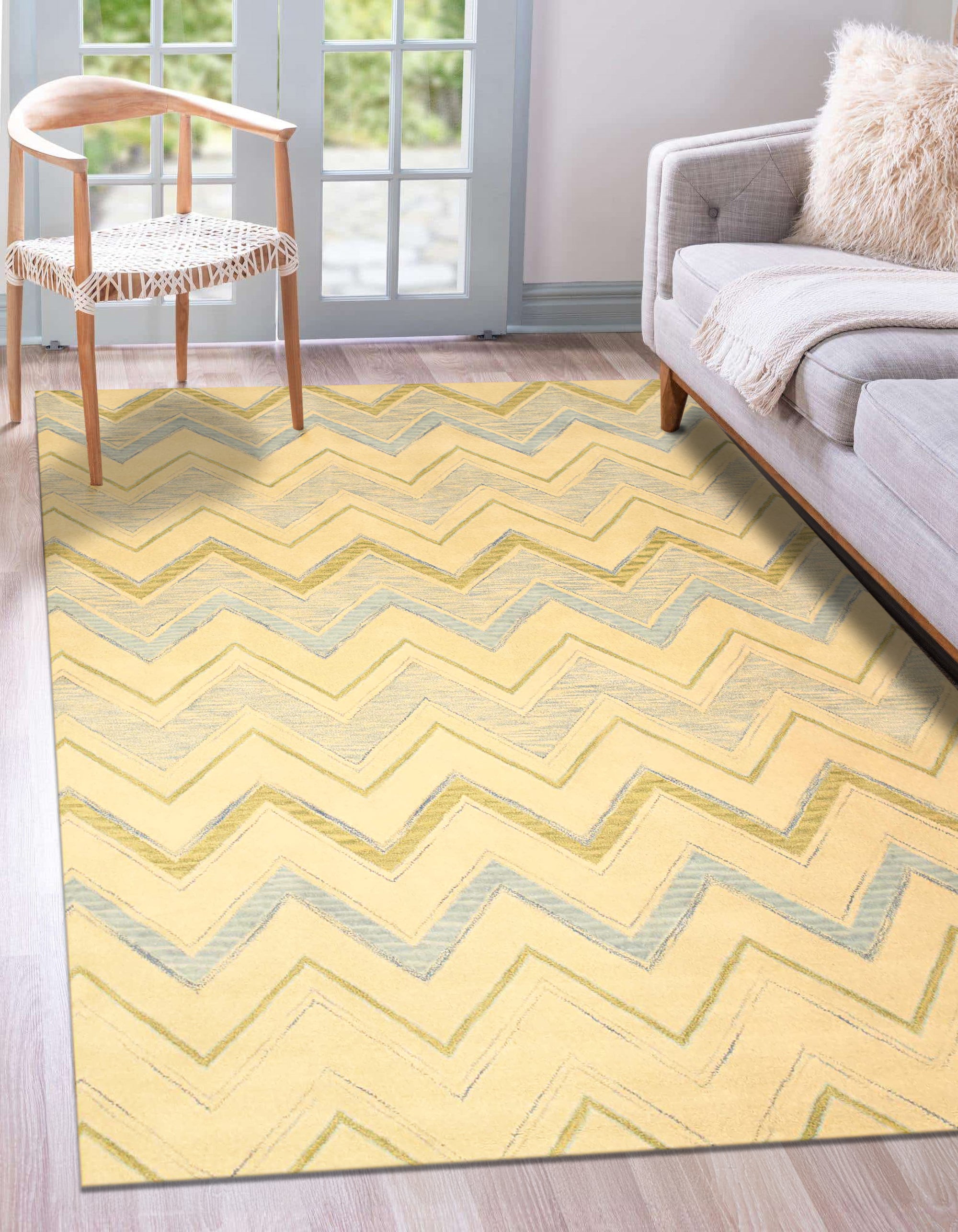 Charming Nadia Ivory Hand Tufted Wool Rug, displaying subtle textures and a warm ivory hue, anchors a bright living space with modern furniture and natural light streaming through sheer curtains.