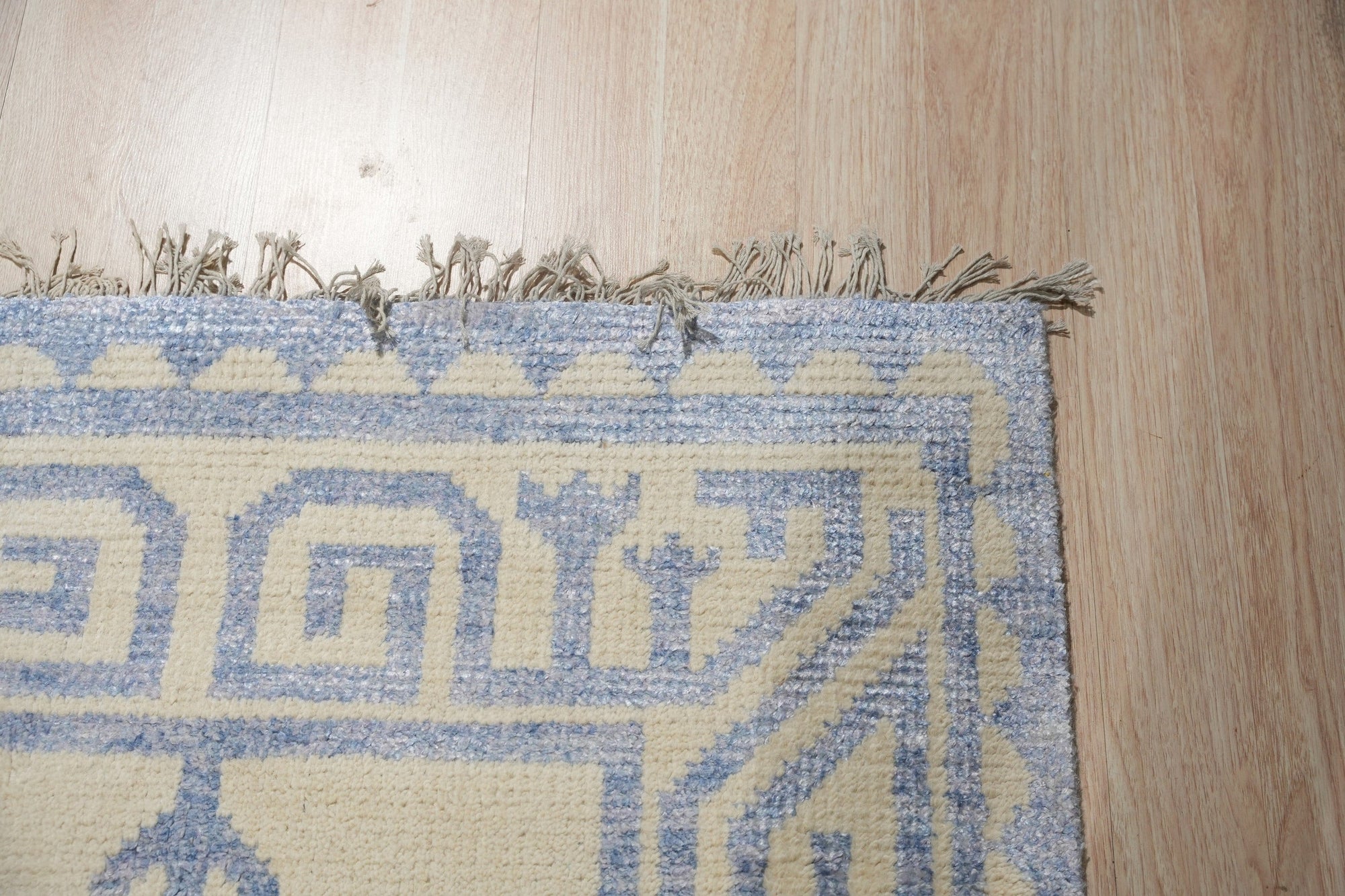 Louie Trara Blue Hand Knotted Wool & Bamboo Silk Rug, a captivating blue rug blending the textures of wool and bamboo silk, displayed in a well-lit interior setting.